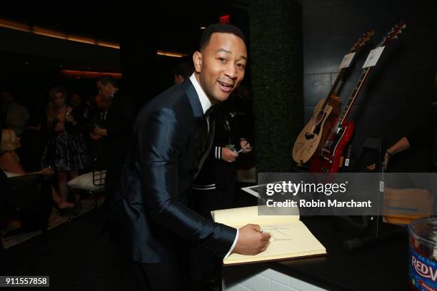 Recording artist John Legend with the GRAMMY Charities Signings during the 60th Annual GRAMMY Awards at Madison Square Garden on January 28, 2018 in...