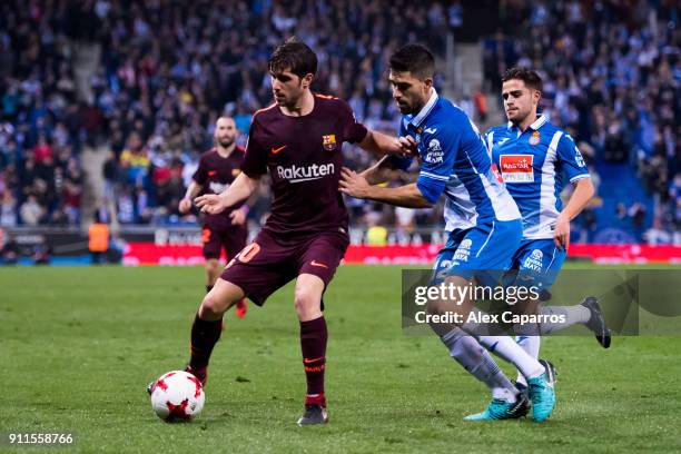 Sergi Roberto of FC Barcelona controls the ball under pressure from Didac Vila of RCD Espanyol during the Spanish Copa del Rey Quarter Final First...