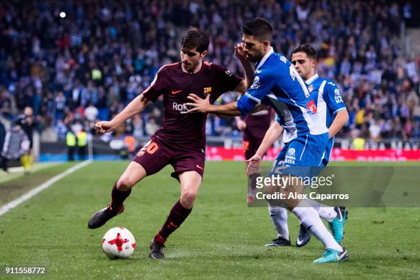 Sergi Roberto of FC Barcelona controls the ball under pressure from Didac Vila of RCD Espanyol during the Spanish Copa del Rey Quarter Final First...