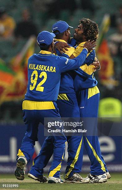 Lasith Malinga of Sri Lanka is congratulated by team mates on the wicket of Paul Collingwood of England during the ICC Champions Trophy Group B match...