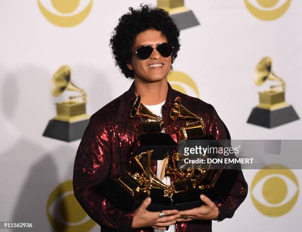 Singer Bruno Mars poses in the press room with his Grammy trophies during the 60th Annual Grammy Awards on January 28 in New York.