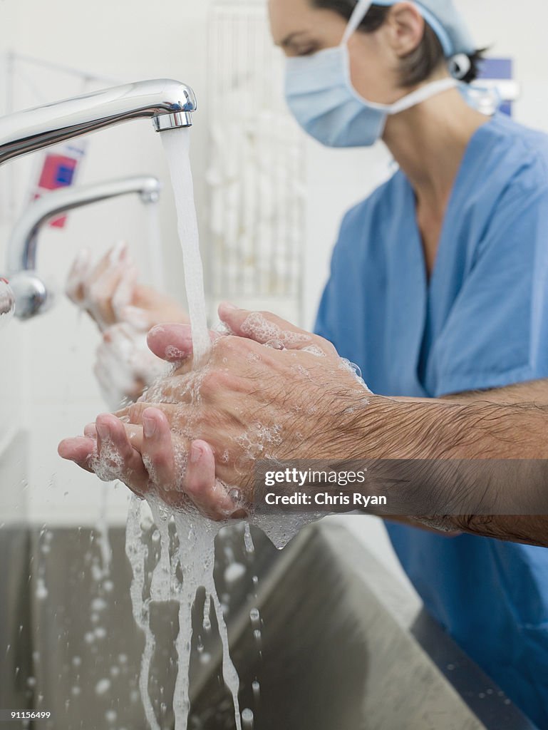 Surgeons washing hands before operation