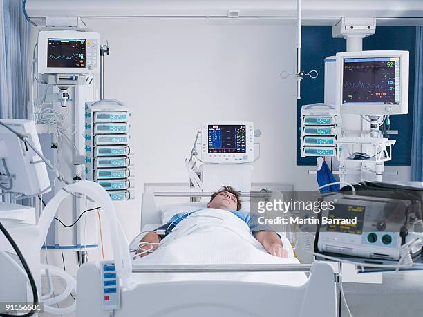 patient in intensive care - hospital bed stockfoto's en -beelden