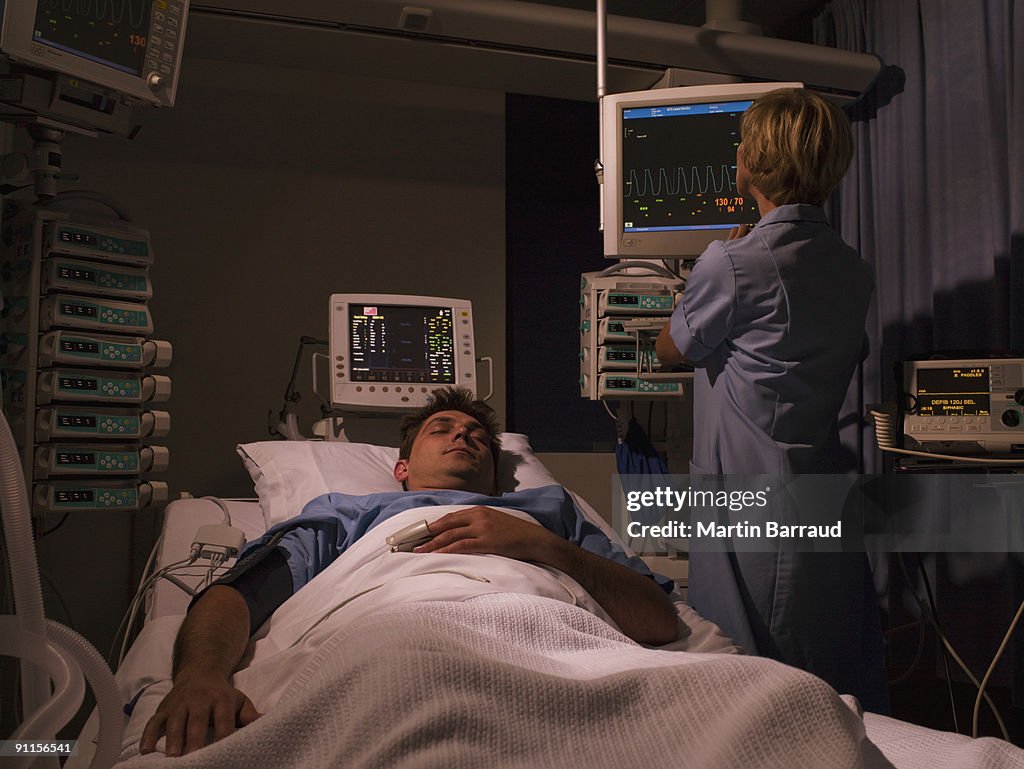 Nurse tending patient in intensive care