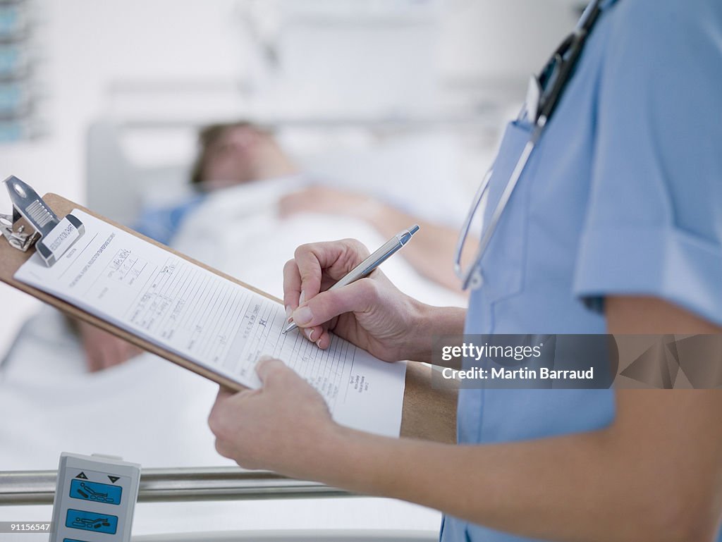 Nurse tending patient in intensive care