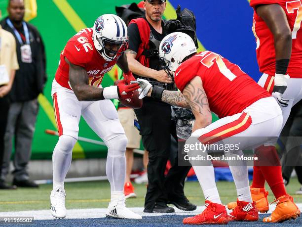 Tight end Delanie Walker and tackle Taylor Lewan both of the Tennessee Titans from the AFC Team celebrate a touchdown by Walker during the NFL Pro...