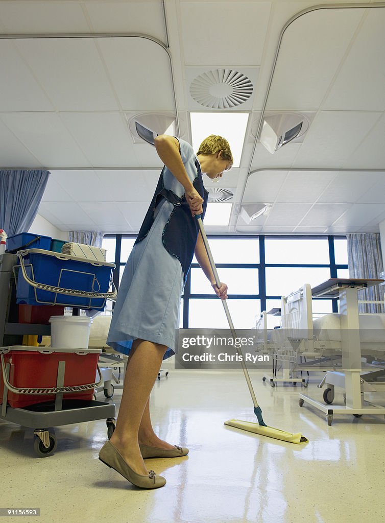 Janitor cleaning hospital room