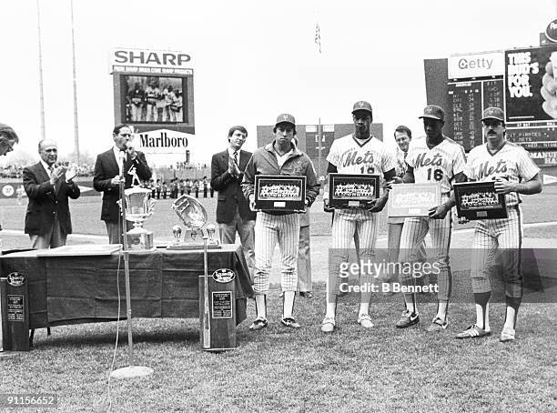 Jesse Orosco, Darryl Strawberry, Dwight Gooden and Keith Hernandez of the New York Mets hold up plaques while being honored before the game against...