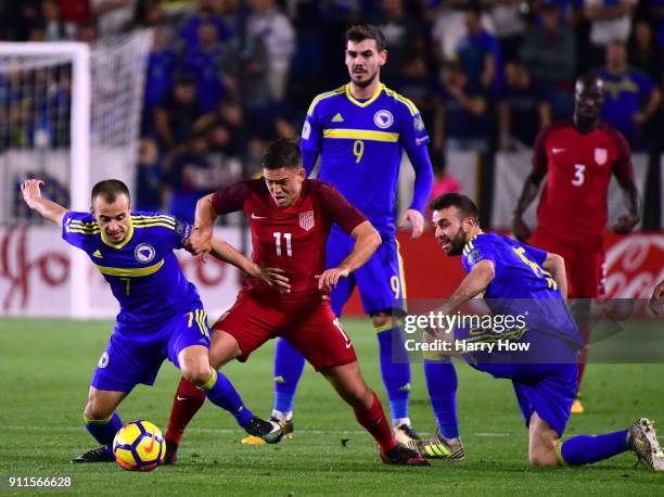 Kelyn Rowe of The United States loses a challenge from Daniel Graovac and Elvis Sarlic of Bosnia Herzegovina during a 0-0 draw at StubHub Center on...