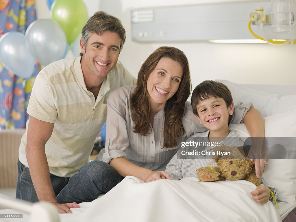 Mother and father visiting son in hospital