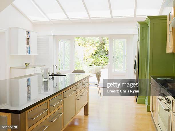 modern kitchen island in kitchen - skylight stock pictures, royalty-free photos & images