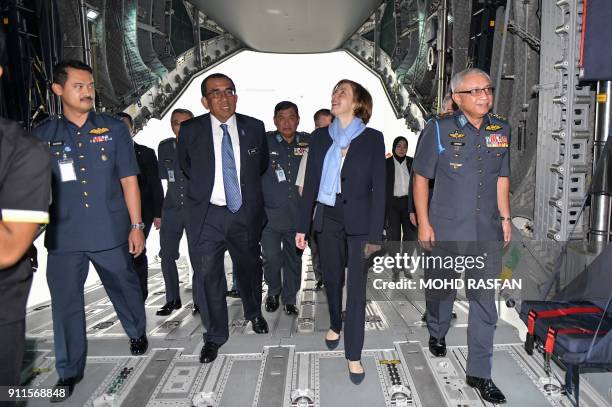 French Defence Minister Florence Parly enters the inside of the Royal Malaysian Air Force Airbus A400M military transport plane during an official...