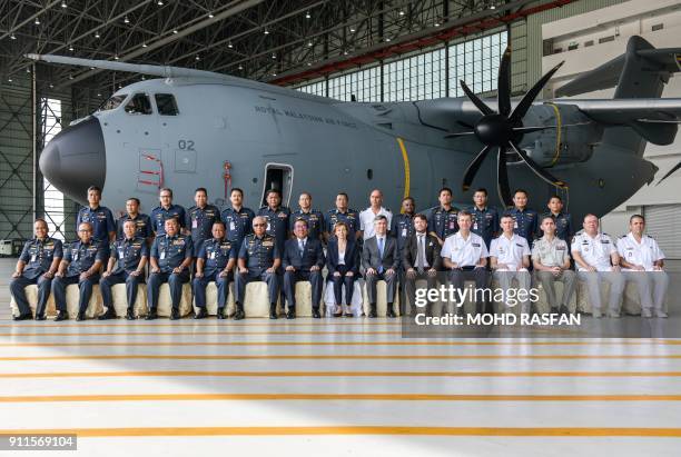 French Defence Minister Florence Parly poses for a "family photo" in front of a Royal Malaysian Air Force Airbus A400M military transport plane...