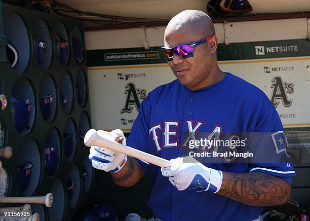 Andruw Jones of the Texas Rangers gets ready in the dugout before the game against the Oakland Athletics at the Oakland-Alameda County Coliseum on...