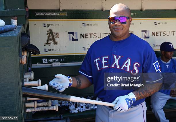 Andruw Jones of the Texas Rangers gets ready in the dugout before the game against the Oakland Athletics at the Oakland-Alameda County Coliseum on...