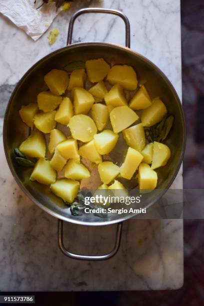 cut boiled potatoes in a roasted tin - roast potatoes stock pictures, royalty-free photos & images