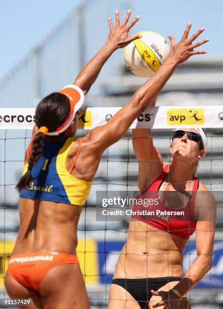 Nicole Branagh of USA hits against the block of Juliana Felisberta Silva of Brazil during the AVP Crocs Tour World Challenge at the Westgate City...