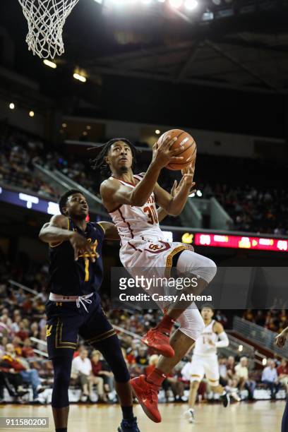 Elijah Stewart scores a layup against Darius McNeill of the California Golden Bears during a NCAA PAC12 college basketball game at Galen Center on...
