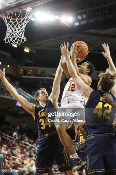 Devin Fleming of the USC Trojans scores a contested shot against Grant Anticevich and Cole Welle of the California Golden Bears during a NCAA PAC12...