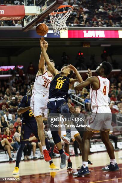 Justice Sueing of the California Golden Bears goes up for a layup against Nick Rakocevic and Chimezie Metu of the USC Trojans during a NCAA PAC12...