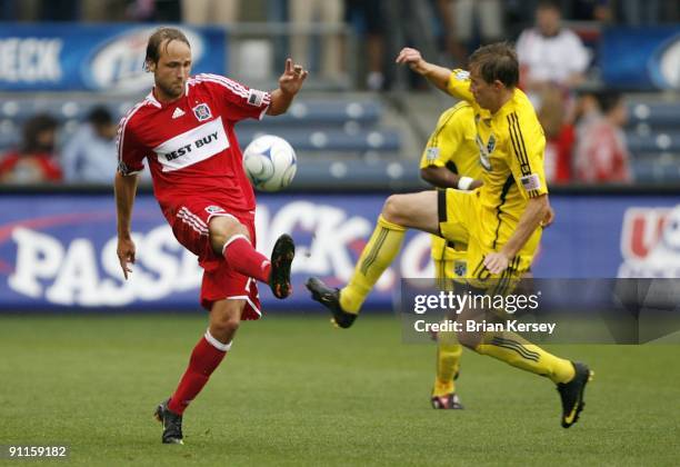 Justin Mapp of the Chicago Fire and Brian Carroll of the Columbus Crew go for the ball during the second half at Toyota Park on September 20, 2009 in...