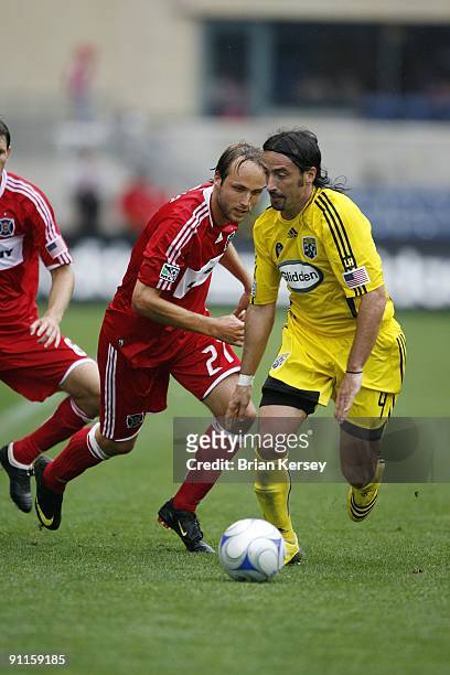 Gino Padula of the Columbus Crew and Justin Mapp of the Chicago Fire chase after the ball during the second half at Toyota Park on September 20, 2009...