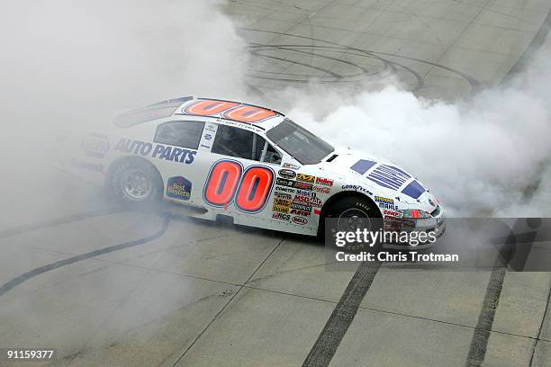 Ryan Truex, driver of the NAPA Toyota, performs a burnout in celebration of winning the NASCAR Camping World Series East Championship after the...