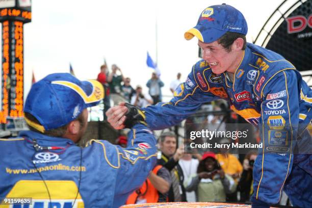 Ryan Truex , driver of the NAPA Toyota, celebrates with a crew member after winning the 2009 NASCAR Camping World Series East Championship at the...