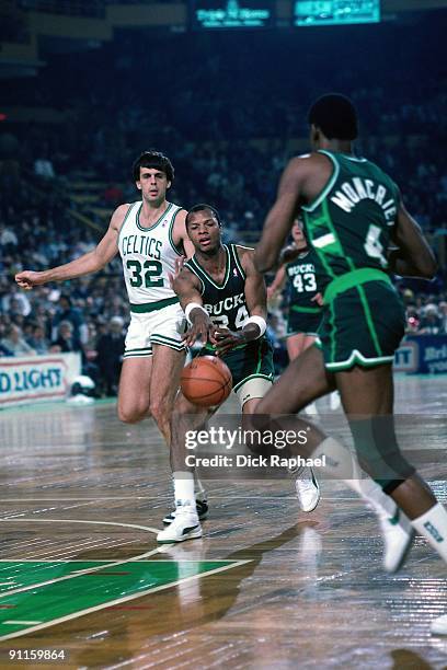 Terry Cummings of the Milwaukee Bucks passes to Sidney Moncrief #E against Kevin McHale of the Boston Celtics during a game played in 1987 at the...