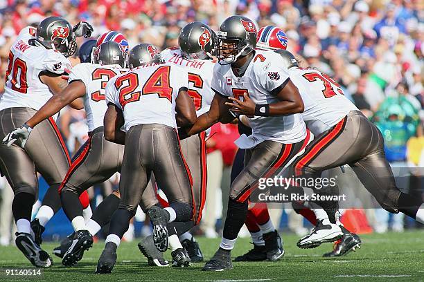 Quarterback Byron Leftwich of the Tampa Bay Buccaneers hands the ball off to running back Cadillac Williams during the game against the Buffalo Bills...