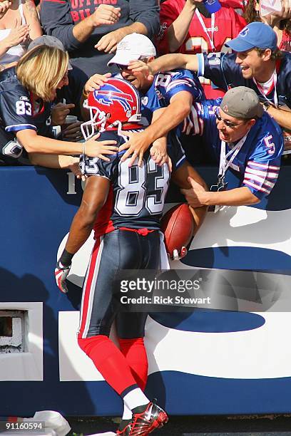 Wide receiver Lee Evans of the Buffalo Bills celebrates with the fans after scoring a touchdown during the first quarter against the Tampa Bay...