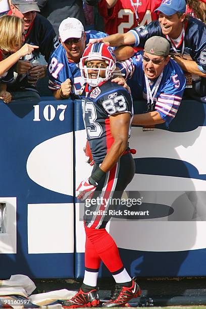 Wide receiver Lee Evans of the Buffalo Bills celebrates with the fans after scoring a touchdown during the first quarter against the Tampa Bay...