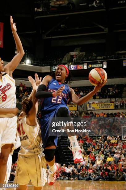 Alexis Hornbuckle of the Detroit Shock shoots over Tully Bevilaqua and Tammy Sutton-Brown of the Indiana Fever during Game Two of the Eastern...
