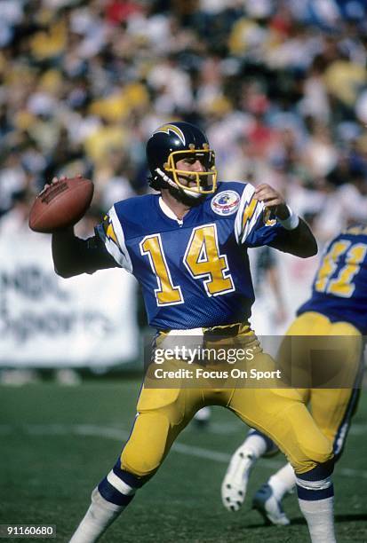 Quarterback Dan Fouts of the San Diego Chargers sets up to throw a pass against the Los Angeles Raiders during an NFL football game October 21, 1984...