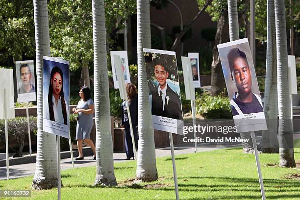 Photos of murder victims are displayed on National Day of Remembrance for Murder Victims on September 25, 2009 in Los Angeles, California. The rally...
