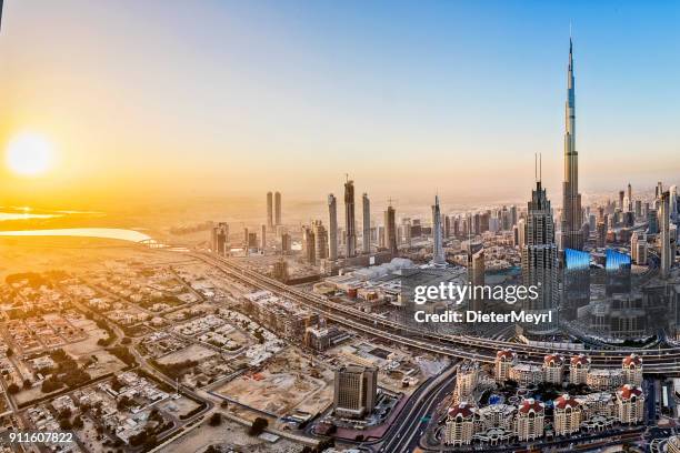 city lights in dubai at sunrise - united arab emirates cityscape stock pictures, royalty-free photos & images