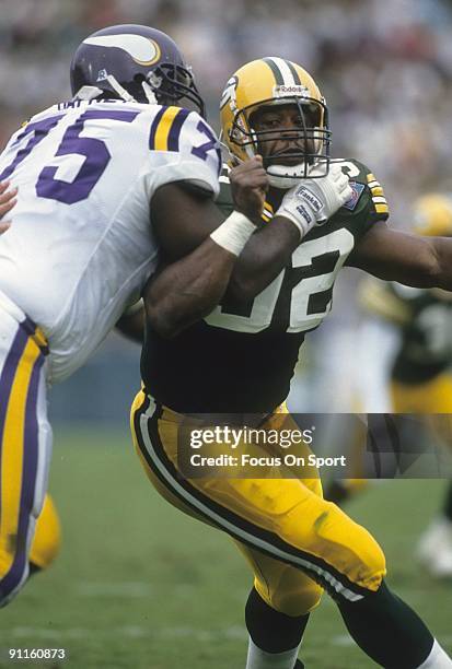 Reggie White of the Green Bay Packers rushes against Bernard Dafney of the Minnesota Vikings during an NFL football game September 4, 1994 at Lambeau...