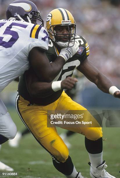 Reggie White of the Green Bay Packers rushes against Bernard Dafney of the Minnesota Vikings during an NFL football game September 4, 1994 at Lambeau...