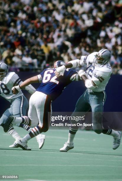 S: Defensive end Ed Jones of the Dallas Cowboys is blocked by Doug Riesenberg of the New York Giants during an NFL football game circa mid 1980's at...