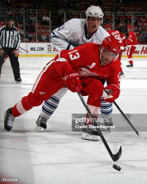 Jiri Tlusty of the Toronto Maple Leafs chases Pavel Datsyuk of the Detroit Red Wings during a NHL pre-season game at Joe Louis Arena on September 25,...