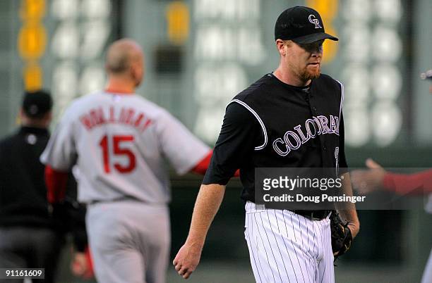 Starting pitcher Aaron Cook of the Colorado Rockies heads to the dugout after Matt Holliday of the St. Louis Cardinals grounded out to first to end...