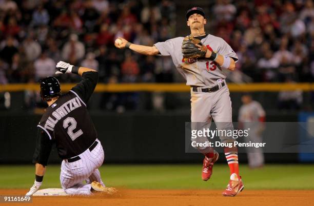 Shortstop Brendan Ryan of the St. Louis Cardinals turns a double play on Troy Tulowitzki of the Colorado Rockies on a ball hit by Brad Hawpe to Cards...