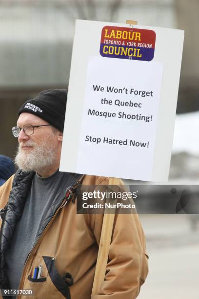 Man holding a sign saying 'We Won't Forget the Quebec Mosque Shooting' during rally held in Toronto, Ontario, Canada, on January 27, 2018. The rally...