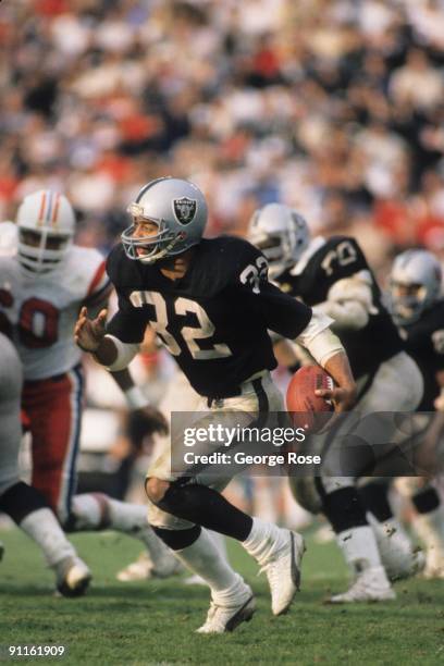 Marcus Allen of the Los Angeles Raiders runs the ball against the New England Patriots during the AFC divisional playoff game at the Los Angeles...