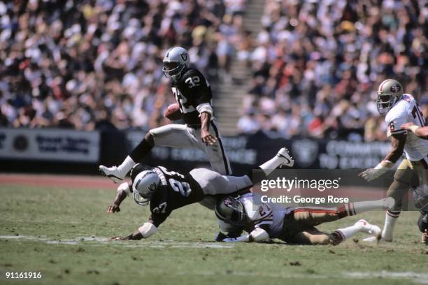 Marcus Allen of the Los Angeles Raiders runs the ball during the game against the San Francisco 49ers at the Los Angeles Memorial Coliseum on...