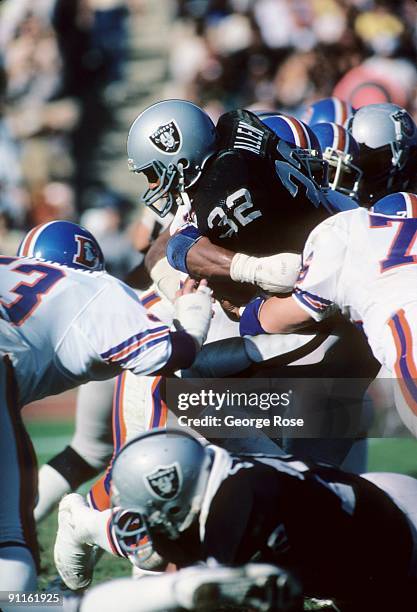 Marcus Allen of the Los Angeles Raiders runs the ball during a game against the Denver Broncos at the Los Angeles Memorial Coliseum on November 13,...