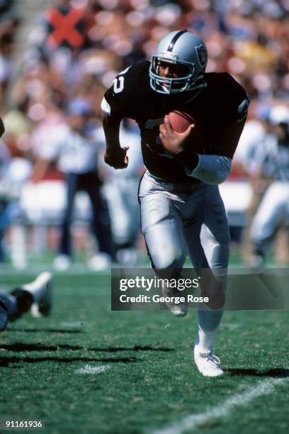 Marcus Allen of the Los Angeles Raiders runs with the ball during a game against the Houston Oilers at the Los Angeles Memorial Coliseum on September...