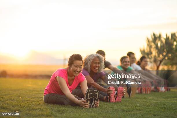 fitness class stretching - family yoga stock pictures, royalty-free photos & images