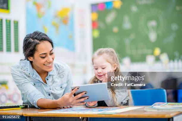 watching a video together - special education stock pictures, royalty-free photos & images