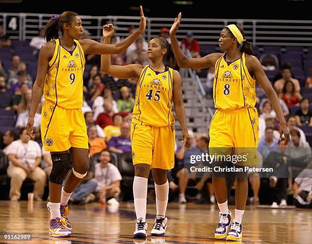Lisa Leslie, Noelle Quinn and DeLisha Milton-Jones of the Los Angeles Sparks celebrate in the final moments of Game Two of the Western Conference...